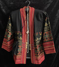 Decorative traditional Thai jacket with intricate patterns and red accents on a black background